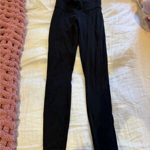 Black Lululemon leggings, athletic material. Full length.
